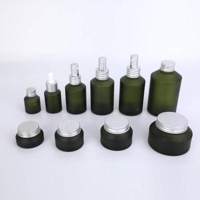 Ensembles de pots de bouteilles de lunettes d'épaule inclinées vertes de soin de la peau
